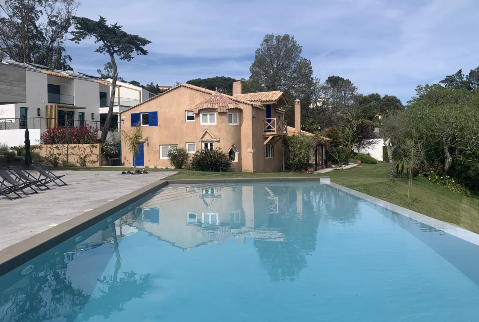 The pool at golden hour, the house behind it